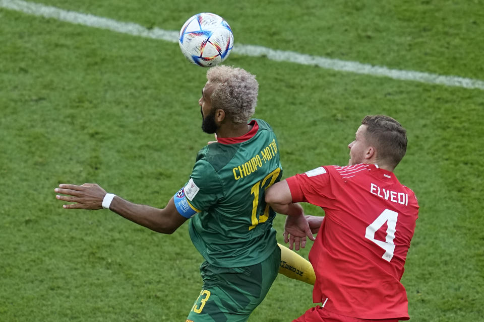 Cameroon's Eric Maxim Choupo-Moting, left, is challenged by Switzerland's Nico Elvedi during the World Cup group G soccer match between Switzerland and Cameroon, at the Al Janoub Stadium in Al Wakrah, Qatar, Thursday, Nov. 24, 2022. (AP Photo/Ebrahim Noroozi)