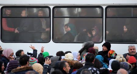 Supporters of Selahattin Demirtas, the jailed leader of the Peoples' Democratic Party (HDP), wait in front of a court house as he went on trial, 13 months after his arrest on terrorism-related charges, in Ankara, Turkey, December 7, 2017. REUTERS/Umit Bektas