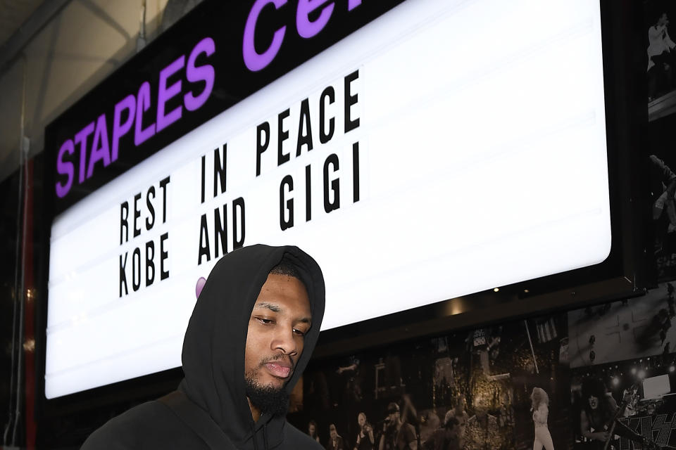 Damian Lillard in front of a Staples Center sign honoring Kobe Bryant. 