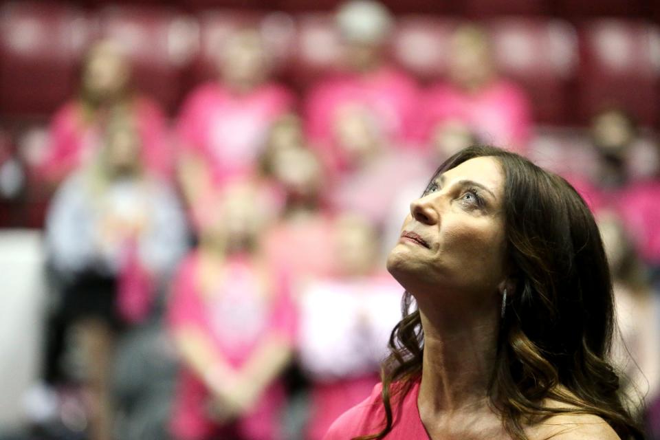 Alabama gymnastics coach Dana Duckworth appears deeply moved as breast cancer survivors are honored before the Crimson Tid'es Power of Pink meet with the University of Georgia Friday, Feb. 11, 2022, in Coleman Coliseum. 