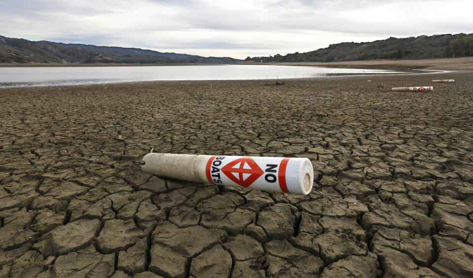 FILE -- In this Feb. 4, 2014 file photo a warning buoy sits on the dry, cracked bed of Lake Mendocino near Ukiah, Calif. Gov. Jerry Brown was governor the last time California had a drought of epic proportions, in 1975-76 and now is pushing a controversial $25 billion plan to build twin tunnels to ship water from the Sacramento-San Joaquin River Delta to farmland and cities further south. (AP Photo/Rich Pedroncelli, file)