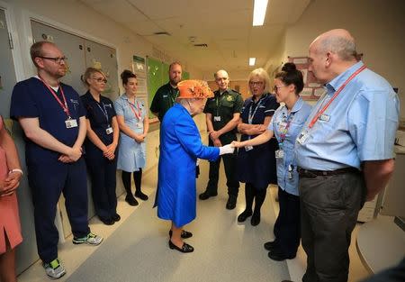 Britain's Queen Elizabeth speaks to staff during a visit to the Royal Manchester Children's Hospital in Manchester, Britain May 25, 2017. REUTERS/Peter Byrne/Pool