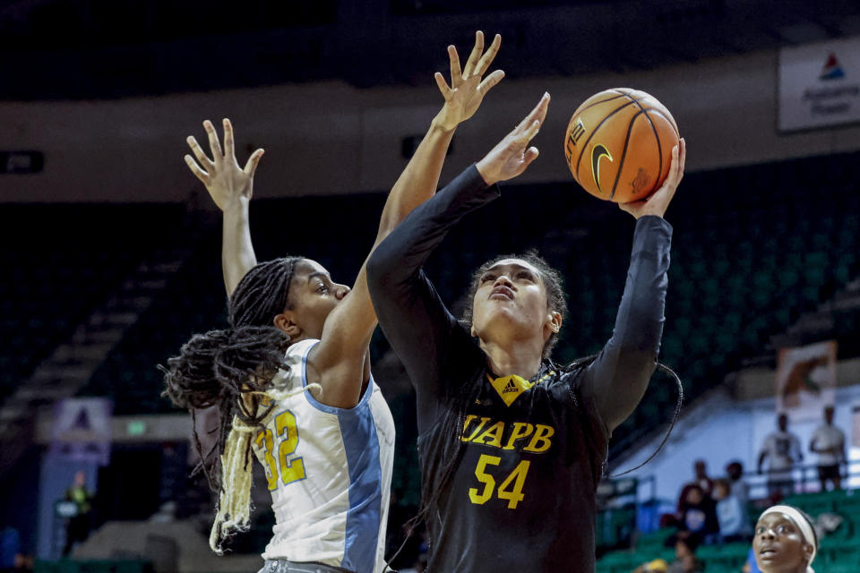 Arkansas-Pine Bluff center Maya Peat (54) puts up a shot around Southern center Xyllize Harrison (32) during the second half of an NCAA college basketball game in the championship of the Southwestern Athletic Conference Tournament, Saturday, March 11, 2023, in Birmingham, Ala. (AP Photo/Butch Dill)