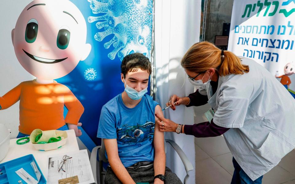 Tomer, aged 18, became one of the first Israeli teenagers to receive the Pfizer vaccine today. - Jack Guez/AFP