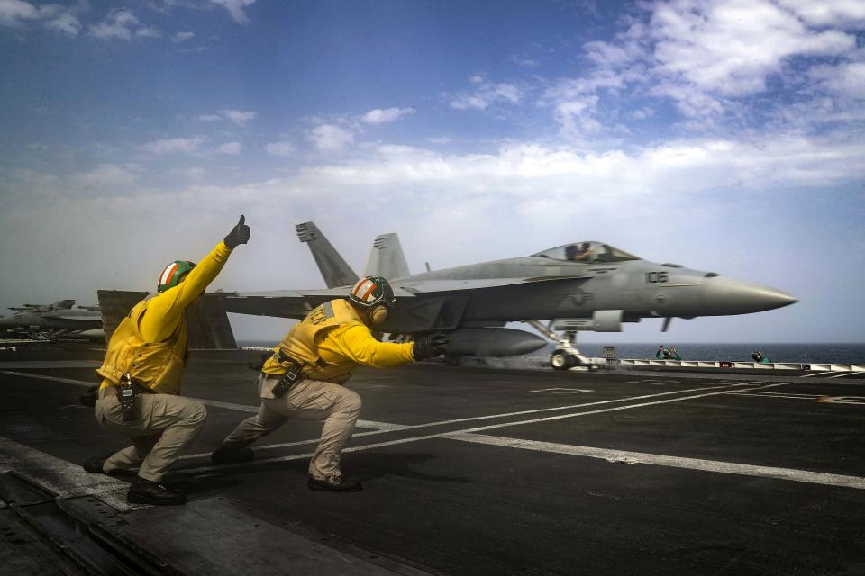 FILE- In this May 16, 2019 file photo, released by the U.S. Navy, an F-18 Super Hornet is launched from the deck of the USS Abraham Lincoln aircraft carrier in the Arabian Sea. For decades considered a U.S. national security priority, the Persian Gulf remains home to tens of thousands of American troops spread across sprawling bases protecting crucial routes for global energy supplies. But while U.S.-Iran tensions in the Gulf appeared close to sparking a global conflagration this summer, attention now rapidly has shifted to Syria. (Mass Communication Specialist 3rd Class Jeff Sherman, U.S. Navy via AP, File)