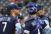 Kansas City Royals starting pitcher Kris Bubic, second form left, is joined on the mound by his teammates and pitching coach Cal Eldred, right, during the first inning of a baseball against the St. Louis Cardinals, Wednesday, May 4, 2022 in Kansas City, Mo. (AP Photo/Reed Hoffmann)