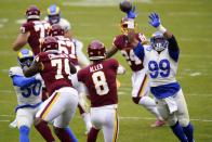 Washington Football Team's Kyle Allen throws with Los Angeles Rams' Aaron Donald rushing during the first half of an NFL football game Sunday, Oct. 11, 2020, in Landover, Md. (AP Photo/Susan Walsh)