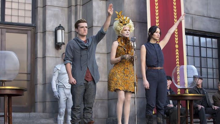 Josh Hutcherson, Elizabeth Banks, and Jennifer Lawrence as Peeta, Effie, and Katniss on stage in The Hunger Games Catching Fire.