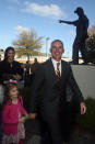 Florida State head football coach Mike Norvell walks with his daughter Mila past the Bobby Bowden statue prior to a news conference Sunday, Dec. 8, 2019, in Tallahassee, Fla. Norvell is Florida State’s new coach, taking over a Seminoles program that has struggled while he was helping to build Memphis into a Group of Five power. (AP Photo/Phil Sears)