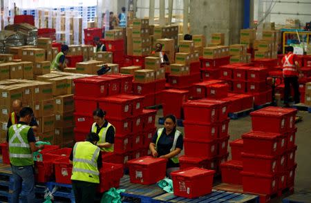 Employees work at RedMart's fulfillment centre in Singapore September 22, 2017. REUTERS/Edgar Su