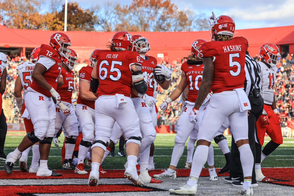 Rutgers Scarlet Knights quarterback Johnny Langan (42) celebrates his touchdown with teammates during the first half against the Maryland Terrapins at SHI Stadium.