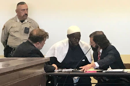 FILE PHOTO: Defense attorney Aleksandar Kostich (R) speaks to defendant Lucas Morton in district court where Morton and five others accused of child abuse were granted bail in Taos County, New Mexico, U.S. August 12, 2018. Picture taken August 12, 2018. REUTERS/Andrew Hay/File Photo