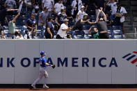 Kansas City Royals right fielder Ryan O'Hearn, lower left, watches as a fan reach for a solo home run hit by New York Yankees Aaron Judge during the first inning of a baseball game, Thursday, June 24, 2021, at Yankee Stadium in New York. (AP Photo/Kathy Willens)