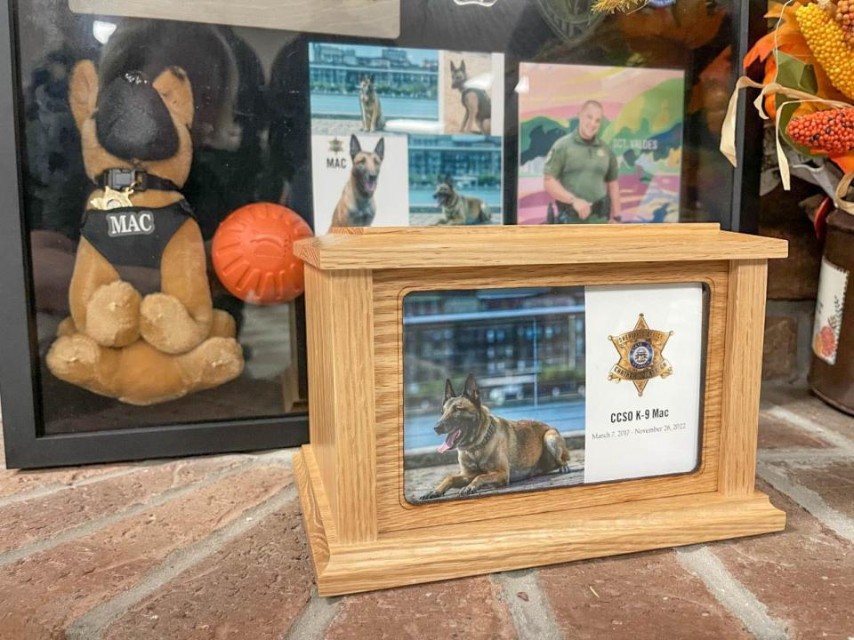 A box containing the cremains of CCSO K-9 Mac is displayed with a memorial during a reception following the End of Watch ceremony for K-9 Mac on Nov. 29, 2022.