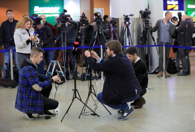 Journalists wait for convicted Russian agent Butina deported after U.S. jail release at an airport outside Moscow