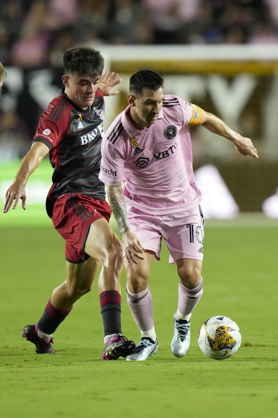 Inter Miami forward Lionel Messi, right, battles for the ball with Toronto FC midfielder Alonso Coello during the first half of an MLS soccer match, Wednesday, Sept. 20, 2023, in Fort Lauderdale, Fla. (AP Photo/Wilfredo Lee)