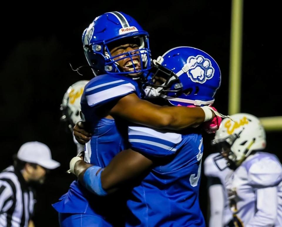 Garinger players celebrate stopping East Meck from making a touchdown