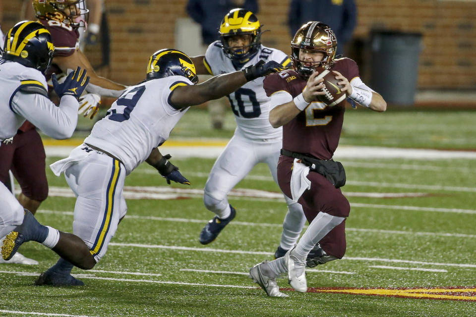 Michigan defensive lineman Kwity Paye (19) getting one of his two sacks aaginst Minnesota on Saturday. (AP Photo/Bruce Kluckhohn)