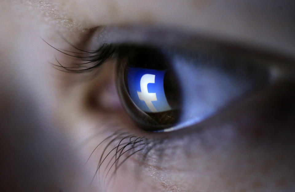 A picture illustration shows a Facebook logo reflected in a person's eye, in Zenica, March 13, 2015. Facebook Inc recorded a slight increase in government requests for account data in the second half of 2014, according to its Global Government Requests Report, which includes information about content removal.Requests for account data increased to 35,051 in the second half of 2014 from 34,946 in the first half, with requests from countries such as India rising and those from others including United States and Germany falling, the report by the world's largest Internet social network showed. Facebook said it restricted 9,707 pieces of content for violating local laws, 11 percent more than in the first half, with access restricted to 5,832 pieces in India and 3,624 in Turkey. Picture taken on March 13. REUTERS/Dado Ruvic (BOSNIA AND HERZEGOVINA - Tags: SOCIETY PORTRAIT SCIENCE TECHNOLOGY BUSINESS TELECOMS TPX IMAGES OF THE DAY)