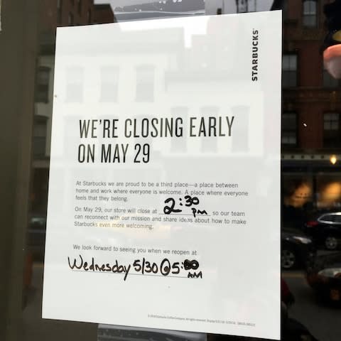 A Starbucks cafe in Portland, Maine, reminding customers that the store will be closed on Tuesday - Credit:  Scott Mayerowitz/ ap