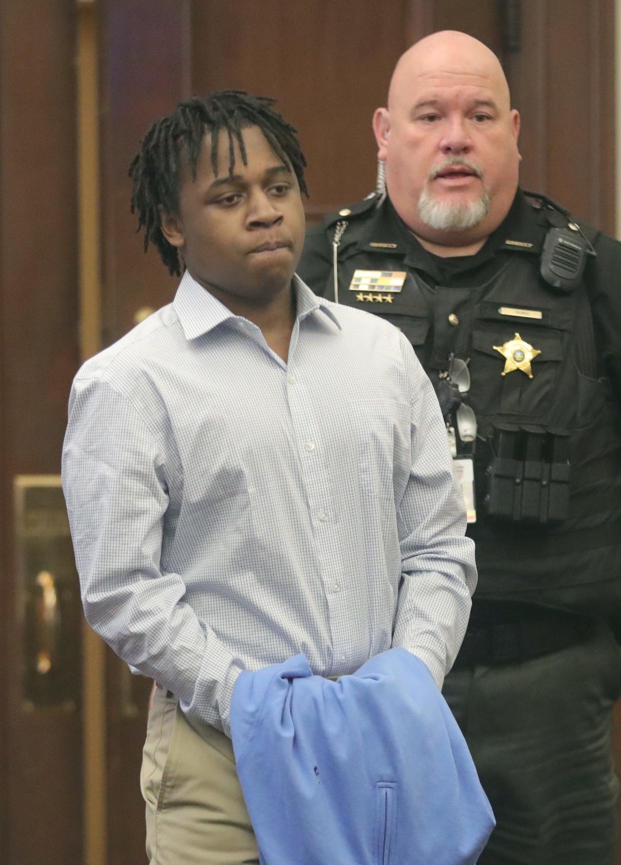 Cameron Jones is escorted into Judge Joy Malek Oldfield's courtroom Friday to hear closing remarks in his trial for the shooting death of Damarcus Hartwell in Akron.