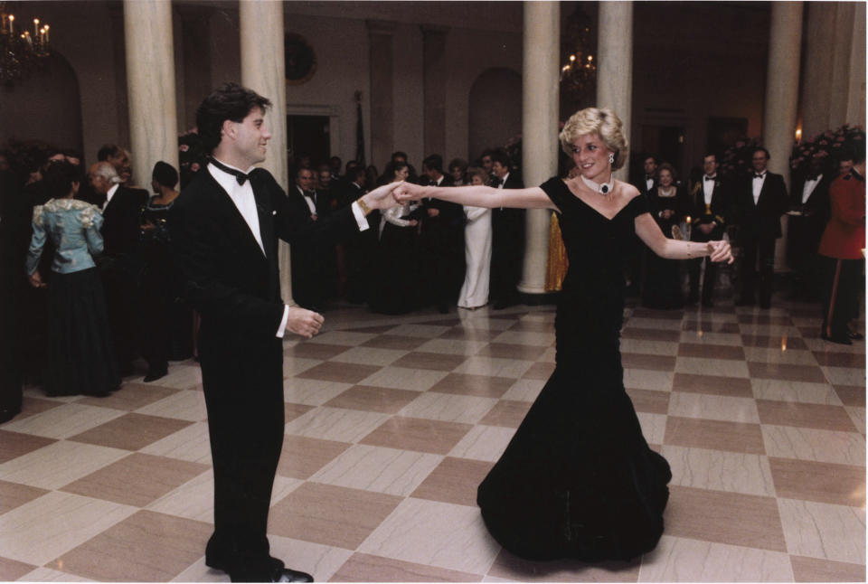 FILE - In this Nov. 9, 1985 photo provided by the Ronald Reagan Library, actor John Travolta dances with Princess Diana at a White House dinner in Washington. Above all, there was shock. That’s the word people use over and over again when they remember Princess Diana’s death in a Paris car crash 25 years ago this week. The woman the world watched grow from a shy teenage nursery school teacher into a glamorous celebrity who comforted AIDS patients and campaigned for landmine removal couldn’t be dead at the age of 36, could she? (AP Photo/Ronald Reagan Library, File)