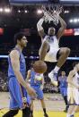 Golden State Warriors' David West (3) dunks next to Oklahoma City Thunder's Enes Kanter, left, during the first half of an NBA basketball game Wednesday, Jan. 18, 2017, in Oakland, Calif. (AP Photo/Marcio Jose Sanchez)