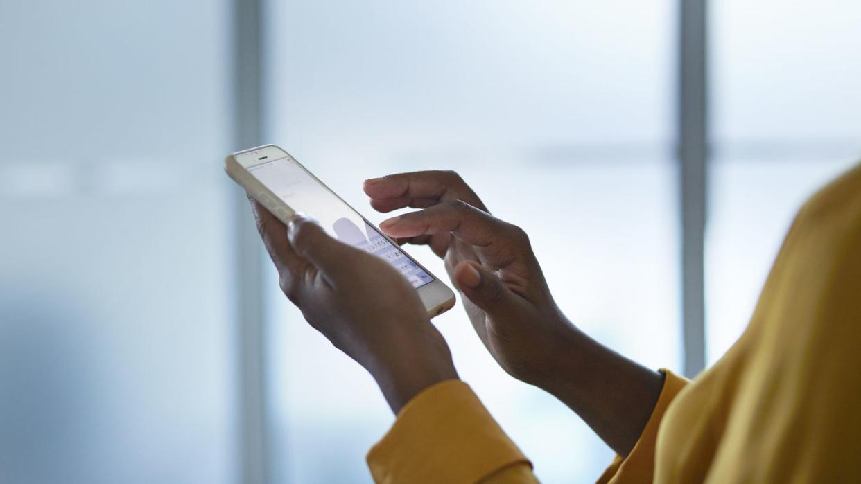 close up of businesswomans hands holding phone