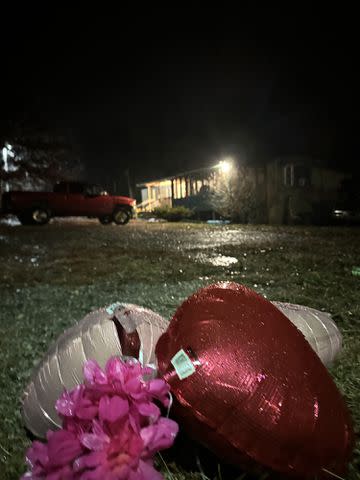 Balloons outside the trailer where Chloe lived and investigators allege her guardian's boyfriend was running a drug operation.