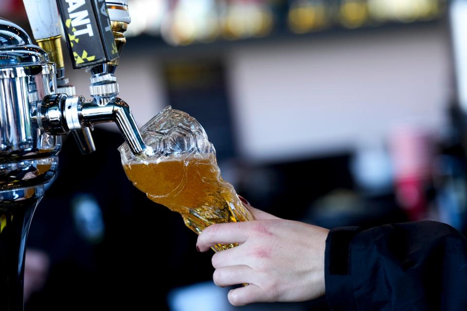 Nov 20, 2022; Columbus, Ohio, United States;  A bartender pours beer into a World Cup celebration beer glass at Lower.com Field during the Crew’s community kickoff event of the World Cup on Sunday morning. Mandatory Credit: Joseph Scheller-The Columbus Dispatch