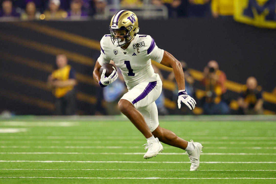 HOUSTON, TEXAS - JANUARY 8: Rome Odunze #1 of the Washington Huskies makes a reception against the Michigan Wolverines during the 2024 CFP National Championship game at NRG Stadium on January 8, 2024 in Houston, Texas. (Photo by Jamie Schwaberow/Getty Images)