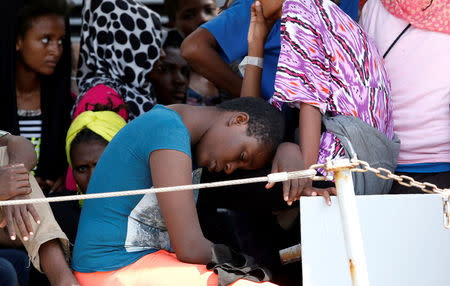 Migrants wait to disembark from the Italian Navy vessel Sfinge in the Sicilian harbour of Pozzallo, southern Italy, August 31, 2016. REUTERS/ Antonio Parrinello