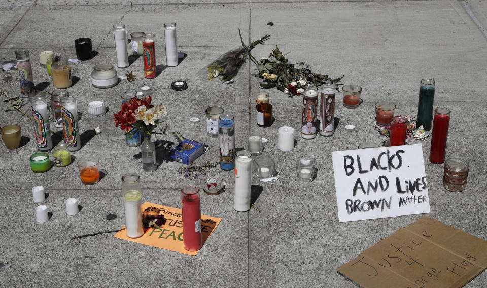 Candles and signs left at the entrance to closed Vallejo city hall seen on Wednesday, June 3, 2020, in Vallejo, Calif. (AP Photo/Ben Margot)