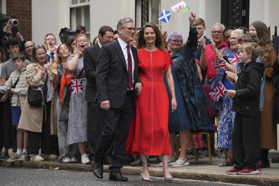 Britain's Labour Party Prime Minister Keir Starmer and his wife Victoria walk past supporters towards 10 Downing Street in London, Friday, July 5, 2024. Labour leader Starmer won the general election on July 4, and was appointed Prime Minster by King Charles III at Buckingham Palace, after the party won a landslide victory. (AP Photo/Kin Cheung)