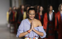Designer Stella Jean accepts applause at the end of her womens Spring/Summer 2018/19 fashion collection, presented in Milan, Italy, Sunday, Sept. 24, 2017. Milan Fashion Week opening Wednesday celebrates perhaps its most diverse season ever, abuzz with new creative directors of color at such storied houses as Salvatore Ferragamo and Bally and marking the return of Haitian-Italian designer Stella Jean after a two-year haitus. But Jean and other industry insiders behind a two-year campaign to open the Italian fashion world to talent from minority backgrounds say true inclusivity remains elusive. (AP Photo/Alberto Pezzali)
