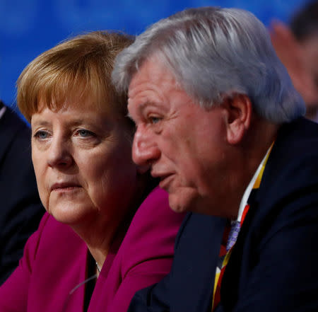 German Chancellor Angela Merkel and Volker Bouffier during a Christian Democratic Union (CDU) party congress in Berlin, Germany, February 26, 2018. REUTERS/Fabrizio Bensch