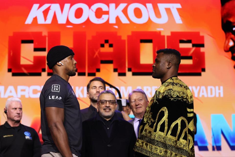 Anthony Joshua (centre left) faces off with Francis Ngannou (Getty Images)