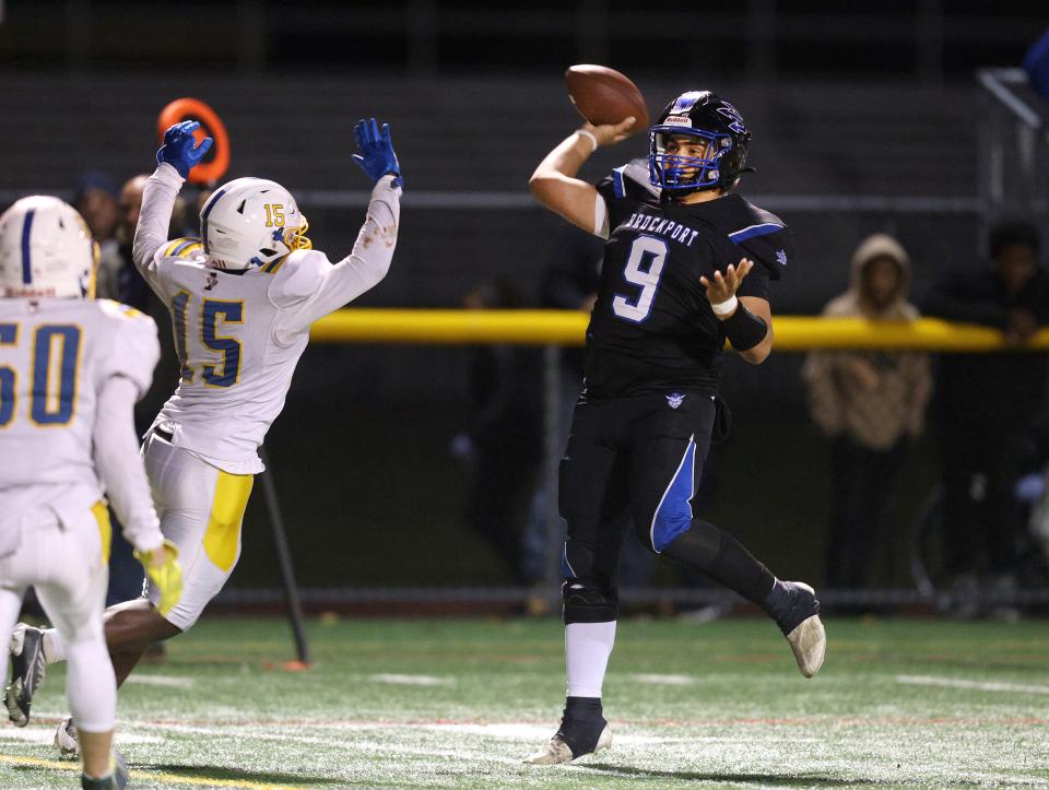 Brockport quarterback Landon Scott makes an off balance throw over Irondequoit's Andre Bigham that was completed for a touchdown to Nathan Parker.