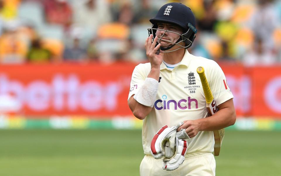 Rory Burns of England walks off the field after being dismissed by Pat Cummins - Getty Images