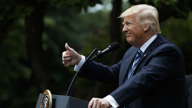 President Donald Trump gestures in the Rose Garden of the White House in Washington, Thursday, May 4, 2017, before signing an executive order aimed at easing an IRS rule limiting political activity for churches.