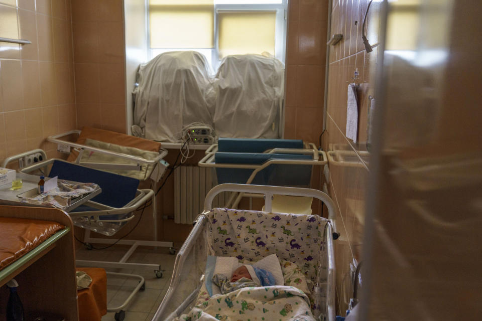 Veronika, a baby born prematurely at 29 weeks, sleeps in a room fortified with sand bags in the windows at the Pokrovsk Perinatal Hospital in Pokrovsk, Donetsk region, eastern Ukraine, Monday, Aug. 15, 2022. The nearest existing infant incubation facility is in the neighboring Dnipropetrovsk region, a 3 1/2 hour drive along secondary roads, a journey considered too risky for women in late-term pregnancy. (AP Photo/David Goldman)