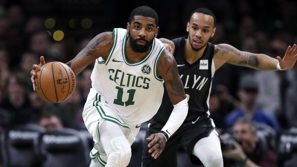 Boston Celtics Kyrie Irving, left, drives against Brooklyn Nets guard D'Angelo Russell during the second half of an NBA basketball game in Boston, Monday, Jan. 28, 2019. The Celtics won 112-104. (AP Photo/Charles Krupa)