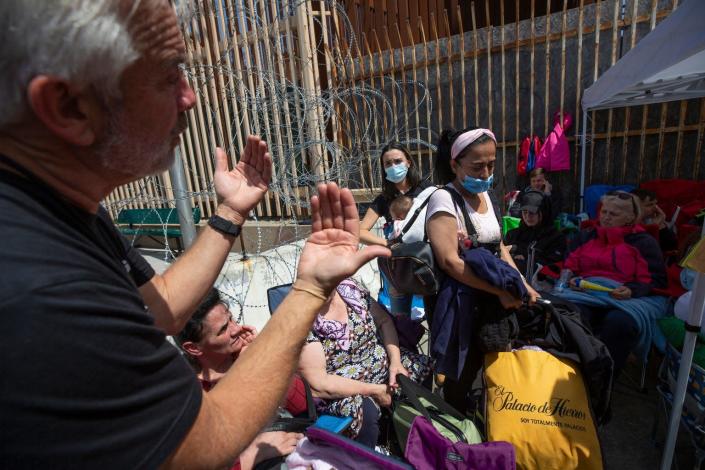 A volunteer asks two Colombian women and a child looking to seek asylum in the U.S. to exit an area used for Ukrainian refugees at the San Ysidro Port of Entry in Tijuana, Baja California on April 5, 2022. 