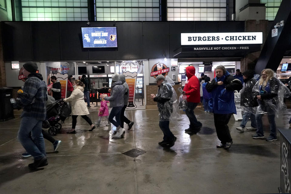 Fans leave the ballpark after a baseball game between the Chicago White Sox and the Baltimore Orioles was postponed because of rain, Friday, May 28, 2021. (AP Photo/Nam Y. Huh)