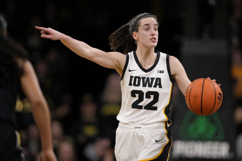 Iowa guard Caitlin Clark (22) directs the team on offense during the second half.