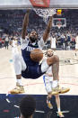 Dallas Mavericks forward Derrick Jones Jr., left, dunks as Los Angeles Clippers guard Amir Coffey watches during the first half in Game 5 of an NBA basketball first-round playoff series Wednesday, May 1, 2024, in Los Angeles. (AP Photo/Mark J. Terrill)