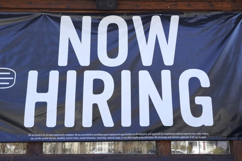 A restaurant displays a "Now Hiring" sign, Thursday, March 4, 2021, in Methuen, Mass.(AP Photo/Elise Amendola)