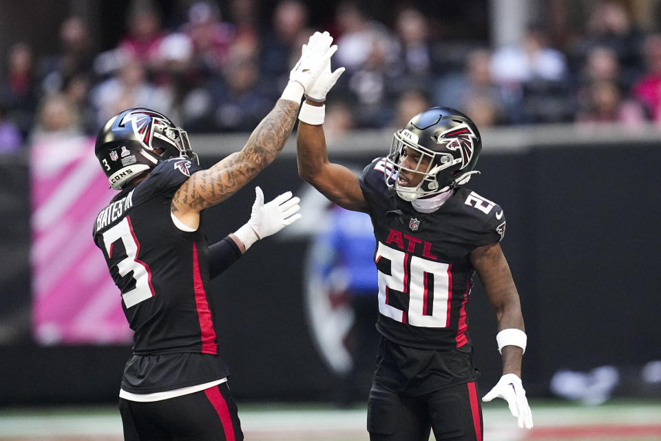 Atlanta Falcons safety Jessie Bates III, left, and cornerback Dee Alford, right, celebrate after a defensive play in the first half of an NFL football game against the Houston Texans in Atlanta, Sunday, Oct. 8, 2023. (AP Photo/Mike Stewart)