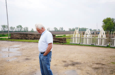 Farmer Ken Ries looks down at the ground outside his hog farm in Ryan, Iowa, U.S., May 18, 2019. Picture taken May 18, 2019. REUTERS/Ben Brewer
