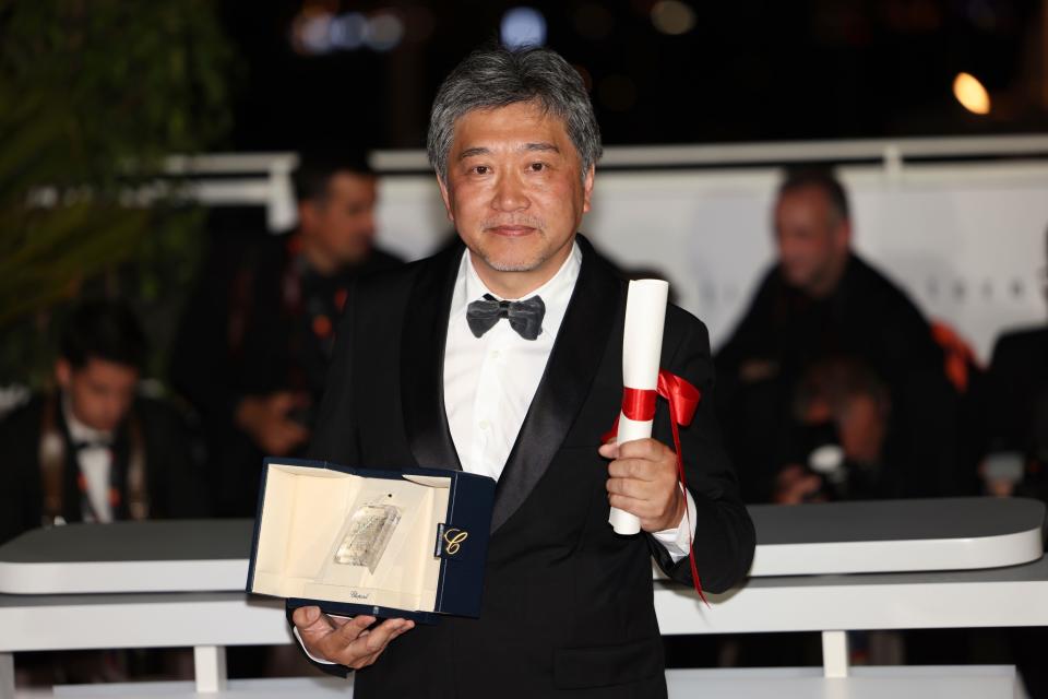 Hirokazu Koreeda, holds the award for best screenplay for 'Monster,' which Koreeda accepted on behalf of Yuji Sakamoto, during a photo call following the awards ceremony at the 76th international film festival, Cannes, southern France, Saturday, May 27, 2023. (Photo by Vianney Le Caer/Invision/AP)